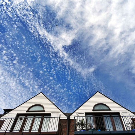 Blue sky above two Wrexham rental properties